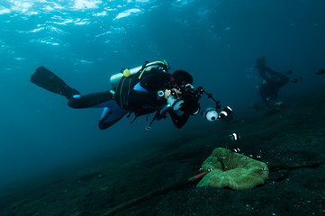 Fototapeta na wymiar diver take a photo video upon coral lembeh indonesia scuba diving