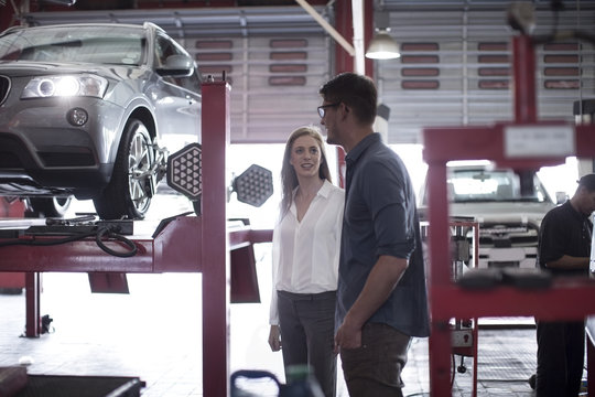 Man showing female customer the tire fitment process