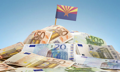 Flag of Arizona sticking in a pile of various european banknotes