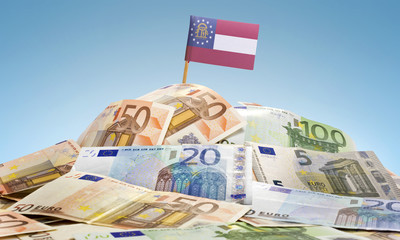 Flag of Georgia sticking in a pile of various european banknotes