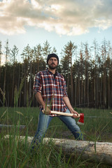 Woodcutter in Hat holding a big Ax in one Hands