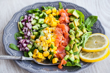 Salmon, avocado, corn, cucumber and onion salad
