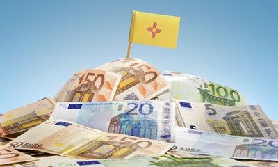 Flag of New Mexico sticking in a pile of various european bankno