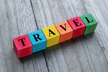 word travel on colorful wooden cubes