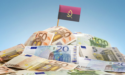 Flag of Angola sticking in a pile of various european banknotes.