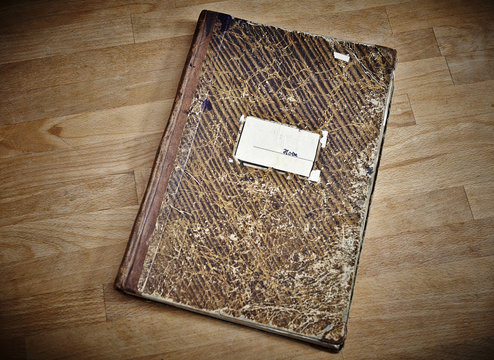 Old notebook on wooden table