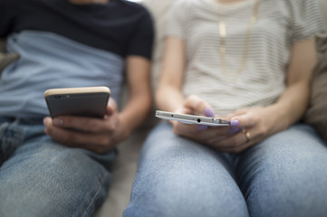 Couples relaxing with a smartphone