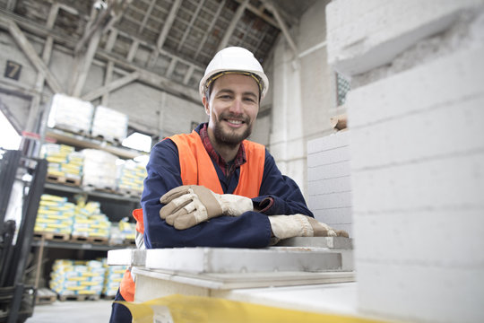 Smiling warehouseman in storehouse