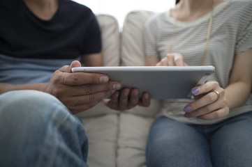 The couple are looking at a tablet together