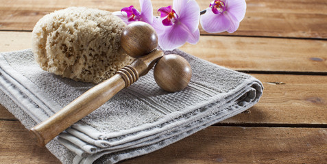 Fototapeta na wymiar concept of massage and washing-up with towel, natural sponge, wooden accessory and orchid flowers for relaxation