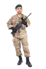 Full length portrait of young man in army clothes holding a weap