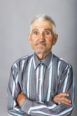 Portrait of an old man with arms folded