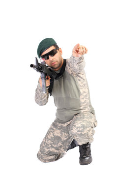 Portrait of soldier or commander holding his rifle and pointing