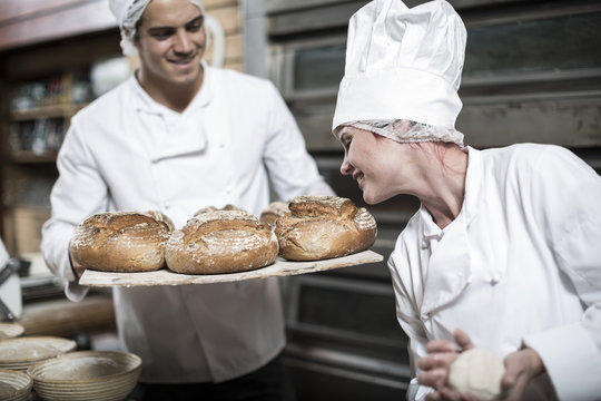 Female baker smelling fresh bread
