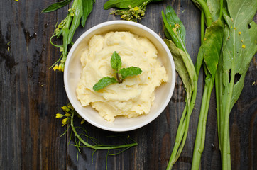 Mashed potato with vegetable on wooden background
