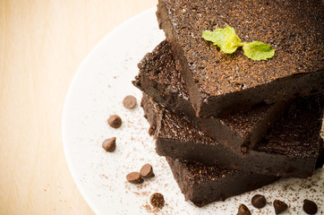 Homemade brownie with chocolate chip on white plate