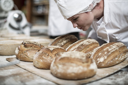 Female baker smelling fresh bread