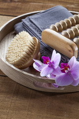 beauty ritual for spa treatment with natural sponge, towel, brush, flowers and massage accessory