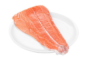 Raw salmon fillet on plate.