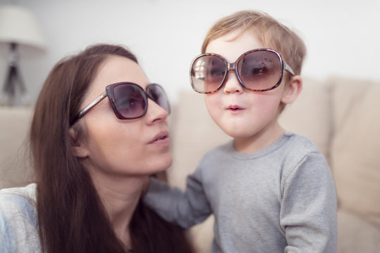 Mother and little son wearing sunglasses