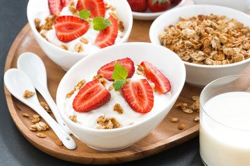healthy breakfast - yogurt, fresh strawberries, granola and milk