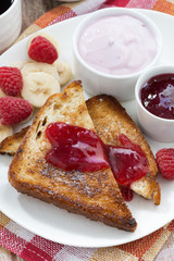 sweet toasts with fresh raspberry, jam and yoghurt for breakfast
