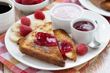 sweet toasts with fresh raspberry, jam and yoghurt for breakfast