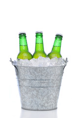 Green beer bottles in a bucket of ice © Steve Cukrov
