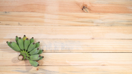 Bunch of ripe bananas on wood floor