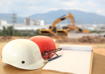 safety helmet on civil engineer working table and work area background