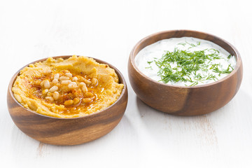 yoghurt sauce and hummus in bowls, close-up