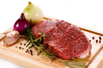 Fresh raw beef on cutting board on white background 