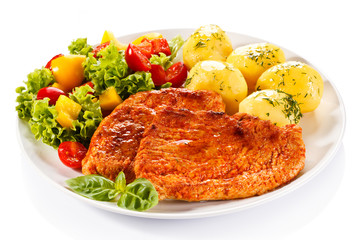 Fried chicken fillets, boiled potatoes and vegetable salad 