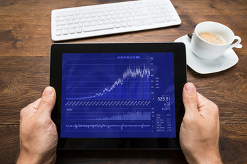 Person Hands With Digital Tablet Showing Graph