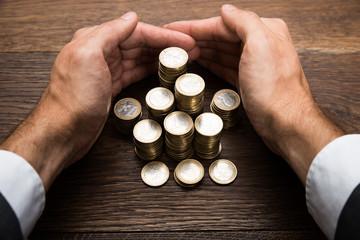 Businessman's Hand Protecting Euro Coins