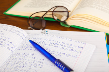 Back to school - blackboard with pencil-box and school equipment on table
