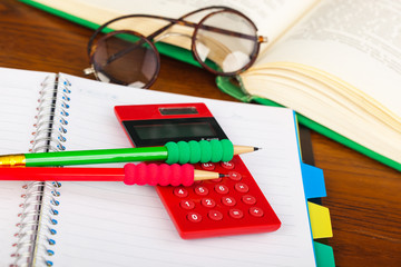 Back to school - blackboard with pencil-box and school equipment on table