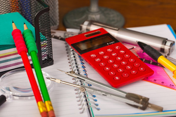 Back to school - blackboard with pencil-box and school equipment on table