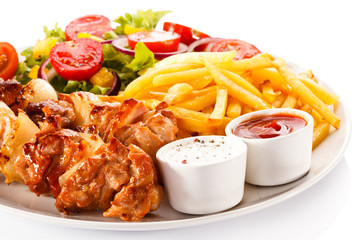 Shashlik - grilled meat, chips and vegetables 