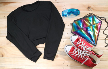 Outfit of traveler, student, teenager, young woman or guy. Overhead of essentials for modern young person. Different objects on wooden background.