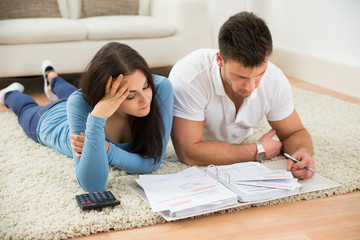 Worried Young Couple Calculating Their Bills At Home