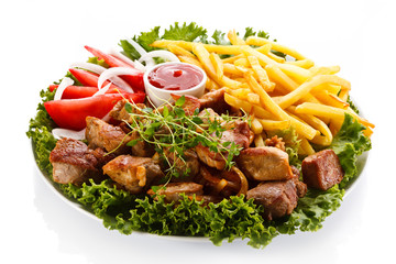 Kebab - grilled meat with French fries and vegetables 