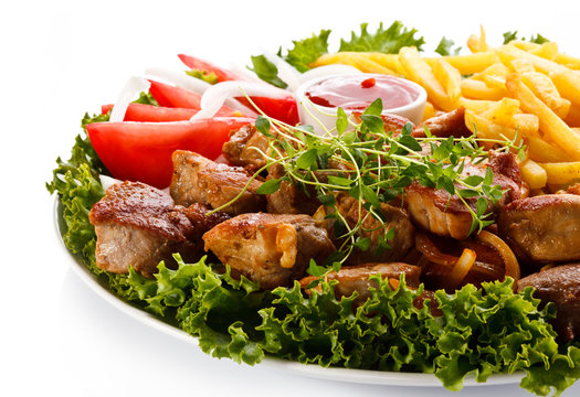 Kebab - grilled meat with French fries and vegetables 