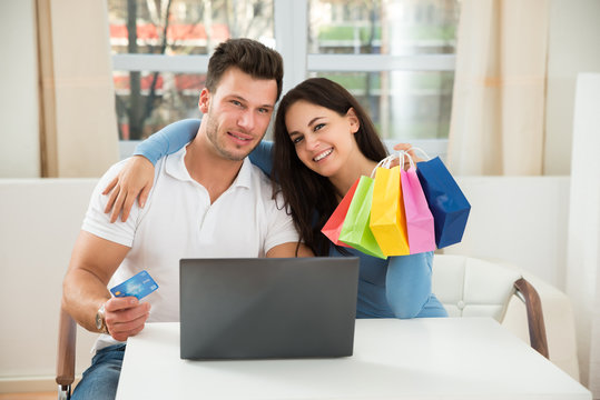 Happy Couple Shopping Online On Laptop