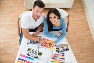 Young Couple Choosing Color From Swatch