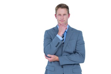 Businessman looking at camera with hand on chin