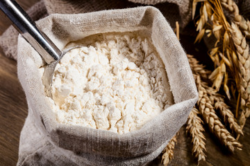 Flour in burlap sack with scoop of metal
