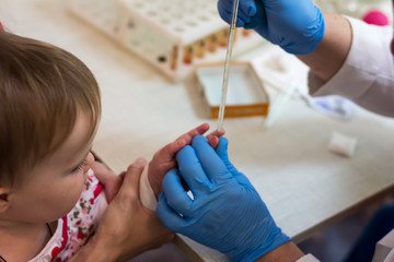 complete blood count/the child looks as from him take blood on the analysis