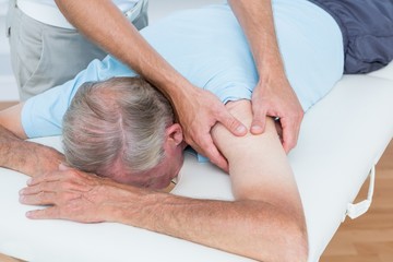Obraz na płótnie Canvas Physiotherapist doing shoulder massage to his patient