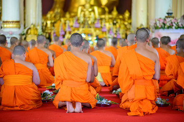 buddhist monks pray to Buddha in Thai temple - obrazy, fototapety, plakaty